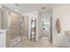 Tiled shower and a towel rack in this neutral and bright bathroom at 15336 Serene Shores Loop, Bradenton, FL 34211