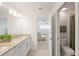 Bathroom with granite countertops, double sinks, shower and commode at 15336 Serene Shores Loop, Bradenton, FL 34211