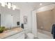 Well-lit bathroom with granite counters, vanity mirror, and shower-tub combo at 15336 Serene Shores Loop, Bradenton, FL 34211