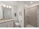 Bathroom featuring a shower, toilet, vanity and sink with granite countertop at 15336 Serene Shores Loop, Bradenton, FL 34211