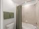 Updated bathroom featuring tiled walls and a shower with a modern shower curtain at 15336 Serene Shores Loop, Bradenton, FL 34211