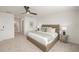 Bright bedroom with carpet, ceiling fan, and a stylish upholstered bed at 15336 Serene Shores Loop, Bradenton, FL 34211