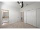 Cozy bedroom with neutral carpet, a ceiling fan, and closet storage at 15336 Serene Shores Loop, Bradenton, FL 34211