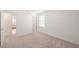 This is a bright, empty bedroom featuring neutral carpet and a closet at 15336 Serene Shores Loop, Bradenton, FL 34211