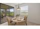 Cozy dining area with sliding glass doors to an outdoor patio and view of the yard at 15336 Serene Shores Loop, Bradenton, FL 34211