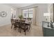Bright dining room featuring stylish chairs, neutral paint, tile floors and natural light from window at 15336 Serene Shores Loop, Bradenton, FL 34211