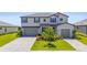 Beautiful two-story home boasts a two-car garage, lush landscaping, and a neatly paved driveway at 15336 Serene Shores Loop, Bradenton, FL 34211