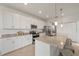 Bright kitchen featuring white cabinets, granite countertops, stainless steel appliances, and seating at 15336 Serene Shores Loop, Bradenton, FL 34211