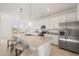 Open-concept kitchen featuring granite counters, stainless steel appliances, and an island with seating at 15336 Serene Shores Loop, Bradenton, FL 34211