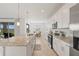 Well-lit kitchen featuring a long island with granite counters, stainless steel appliances, and plenty of cabinet space at 15336 Serene Shores Loop, Bradenton, FL 34211