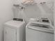 Clean and functional laundry area with modern washer and dryer units and wire shelving at 15336 Serene Shores Loop, Bradenton, FL 34211