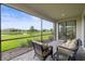 Inviting screened patio features outdoor seating with serene views of the lake and green space at 15336 Serene Shores Loop, Bradenton, FL 34211