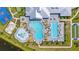 Aerial view of a large community pool with various swimming areas, lounge chairs, and lush landscaping at 15336 Serene Shores Loop, Bradenton, FL 34211