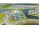 Aerial view of a community's amenities, including tennis and basketball courts, a putting green, and clubhouse at 15336 Serene Shores Loop, Bradenton, FL 34211