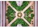 Serene aerial view of a landscaped courtyard with lush greenery and a fountain at 1613 Gondola Park Dr # 1613, Venice, FL 34292