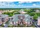 Aerial view of attractive condo building featuring mature trees and manicured grounds at 1613 Gondola Park Dr # 1613, Venice, FL 34292