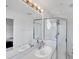 Bright bathroom features a double vanity, a large mirror, and a glass-enclosed shower at 1613 Gondola Park Dr # 1613, Venice, FL 34292