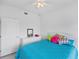 Comfortable bedroom featuring a ceiling fan, a mirror, and colorful pillows on the bed at 1613 Gondola Park Dr # 1613, Venice, FL 34292