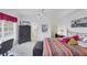 Comfortable bedroom with colorful bedding and a view of the en-suite bathroom at 1613 Gondola Park Dr # 1613, Venice, FL 34292