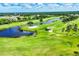 Scenic aerial view of a lush golf course with ponds, sand traps, and meticulously manicured greens at 1613 Gondola Park Dr # 1613, Venice, FL 34292