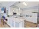 A modern kitchen with white cabinets, marble countertop, and stainless steel appliances at 1613 Gondola Park Dr # 1613, Venice, FL 34292