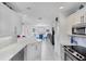 Bright kitchen and dining area with white cabinets and stainless steel appliances at 1613 Gondola Park Dr # 1613, Venice, FL 34292