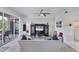 Living room with an entertainment center, ceiling fan, and sliding glass doors to the outside balcony at 1613 Gondola Park Dr # 1613, Venice, FL 34292