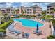 The community pool area features ample seating, lush landscaping, and a relaxing atmosphere for residents at 1613 Gondola Park Dr # 1613, Venice, FL 34292