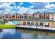 View of the outdoor community pool with sun loungers, lush landscaping, and access to the lake at 1613 Gondola Park Dr # 1613, Venice, FL 34292