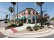 Picturesque corner building with colorful awnings, flower boxes, and palm trees enhancing the street's charm at 1613 Gondola Park Dr # 1613, Venice, FL 34292