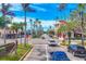 Lush downtown street with retail buildings, tropical palm trees, and well-defined crosswalks at 1613 Gondola Park Dr # 1613, Venice, FL 34292