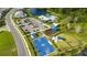 An aerial view showcases a community recreation area with a pool, playground, basketball court, and parking at 16418 Slate Pl, Lakewood Ranch, FL 34211
