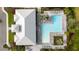 Aerial view of a large T-shaped community pool surrounded by lounge chairs and palm trees at 16418 Slate Pl, Lakewood Ranch, FL 34211