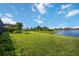 Expansive green backyard with a scenic pond view, perfect for relaxation and outdoor activities at 16418 Slate Pl, Lakewood Ranch, FL 34211
