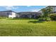 The screened-in lanai is surrounded by a lush green yard, offering a perfect outdoor living space at 16418 Slate Pl, Lakewood Ranch, FL 34211