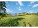 Lush green backyard and beautiful pond view, creating a serene and picturesque outdoor setting at 16418 Slate Pl, Lakewood Ranch, FL 34211
