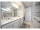Bathroom features a double sink vanity, large mirror, and tiled walk-in shower at 16418 Slate Pl, Lakewood Ranch, FL 34211