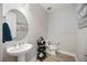 Stylish powder room with a pedestal sink and modern fixtures at 16418 Slate Pl, Lakewood Ranch, FL 34211