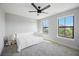 Well-lit bedroom with a large window and plush carpet at 16418 Slate Pl, Lakewood Ranch, FL 34211