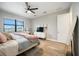 Bright bedroom with modern ceiling fan, stylish furniture, and window with water view at 16418 Slate Pl, Lakewood Ranch, FL 34211