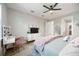Bedroom features a plush bed, stylish vanity, and sleek dresser with mounted TV at 16418 Slate Pl, Lakewood Ranch, FL 34211