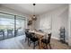 Cozy dining area featuring a wooden table, black chairs, and natural light from the adjacent sliding glass door at 16418 Slate Pl, Lakewood Ranch, FL 34211