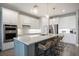 Modern kitchen with white cabinets, stainless steel appliances, and a large center island with seating at 16418 Slate Pl, Lakewood Ranch, FL 34211