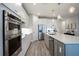 Contemporary kitchen with stainless steel appliances, custom cabinets, and a spacious center island at 16418 Slate Pl, Lakewood Ranch, FL 34211