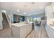 Kitchen with a large center island, modern lighting, and an open layout that connects to the living spaces at 16418 Slate Pl, Lakewood Ranch, FL 34211