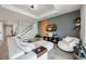 Comfortable living room featuring a large sectional sofa, stylish decor, and a mounted TV at 16418 Slate Pl, Lakewood Ranch, FL 34211