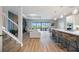 Spacious living room with a view of the outdoor pool area, seamlessly connected to the kitchen and dining space at 16418 Slate Pl, Lakewood Ranch, FL 34211