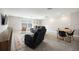 This spacious living room is equipped with a sofa, chairs, table, and rug at 16418 Slate Pl, Lakewood Ranch, FL 34211