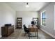 Home office with wood-look floors, modern desk, and natural light at 16418 Slate Pl, Lakewood Ranch, FL 34211