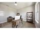 Home office with wood-look floors, modern desk, and natural light at 16418 Slate Pl, Lakewood Ranch, FL 34211